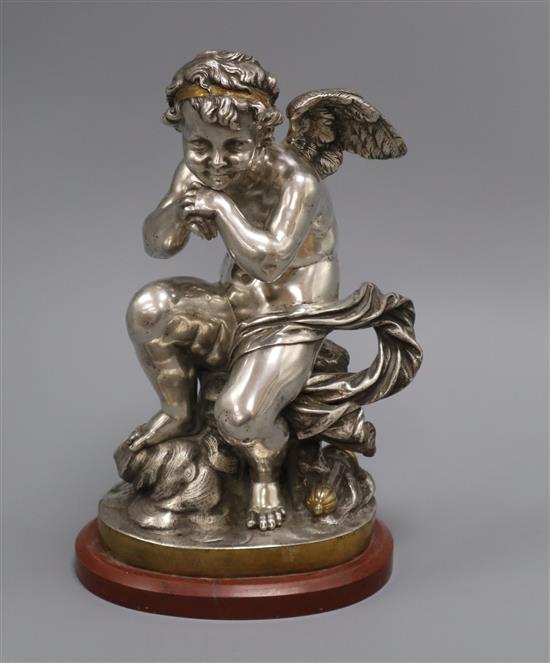 A silver and gilded French bronze of a seated Putti height 30cm